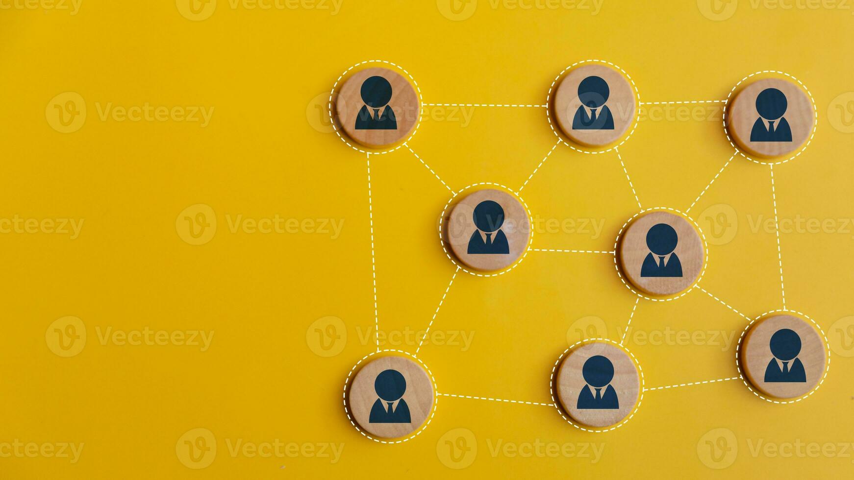 Wooden blocks connected together on a yellow background. Teamwork, network, and community concept. photo