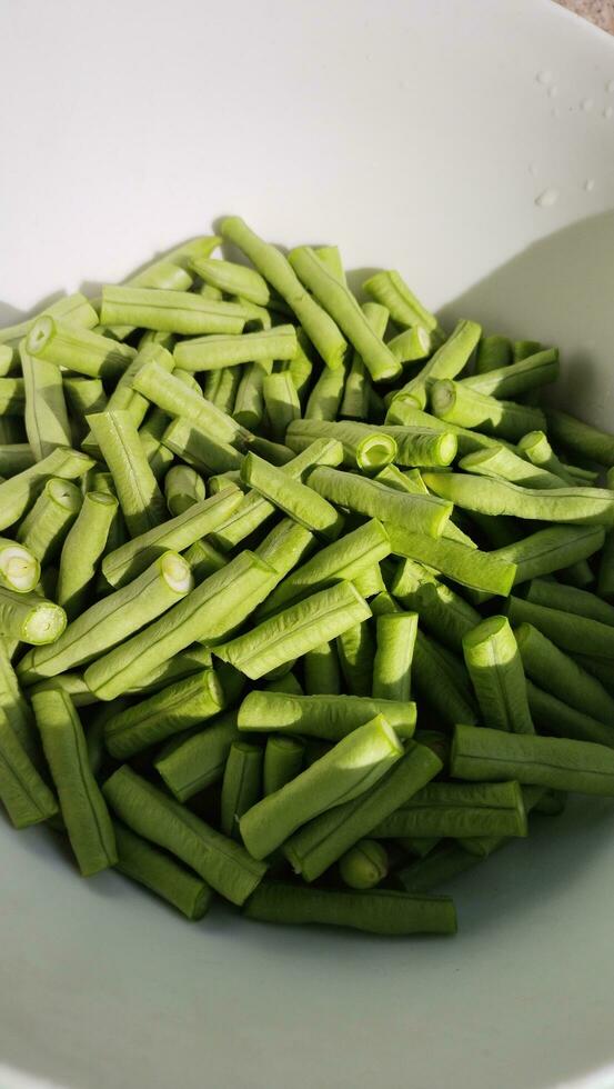 Long bean pieces in a bowl. photo