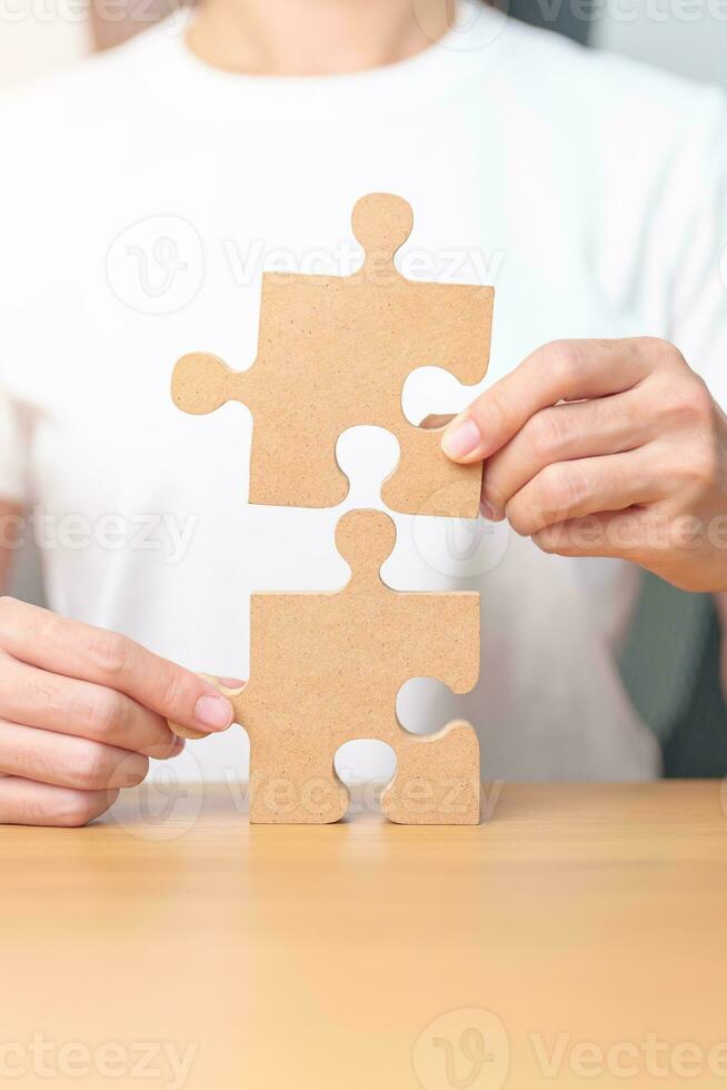 Hand connecting couple puzzle piece. Business Solving, mission, challenge, success, goals, target and strategy concepts photo