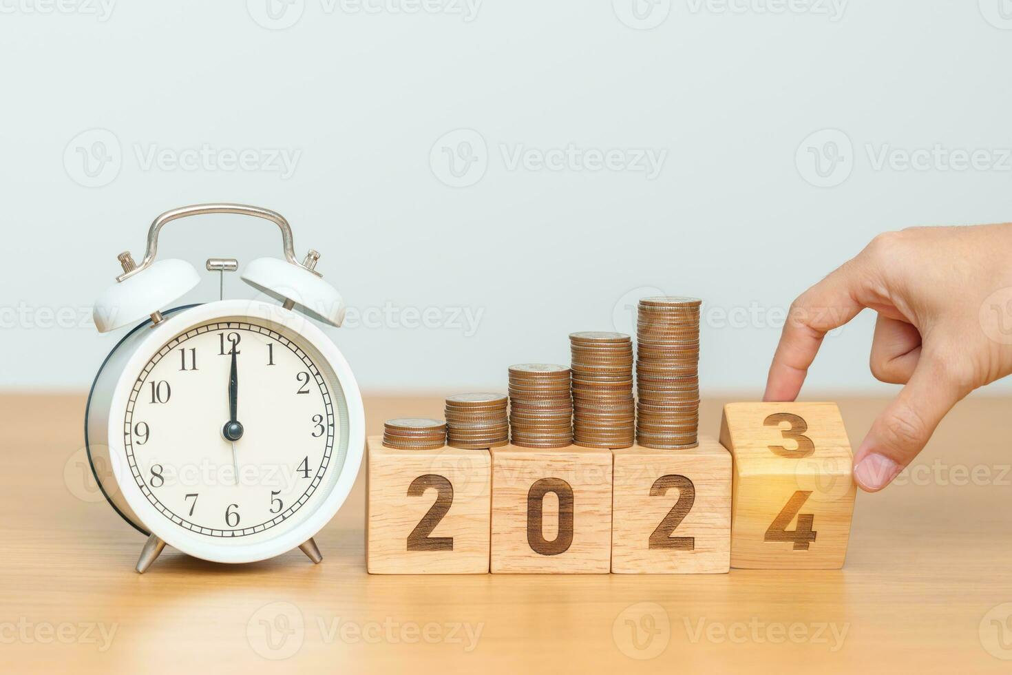 Happy New Year with vintage alarm clock and flipping 2023 change to 2024 block. Resolution, Goals, Plan, Action, Money Saving, Retirement fund, Pension, Investment and Financial concept photo