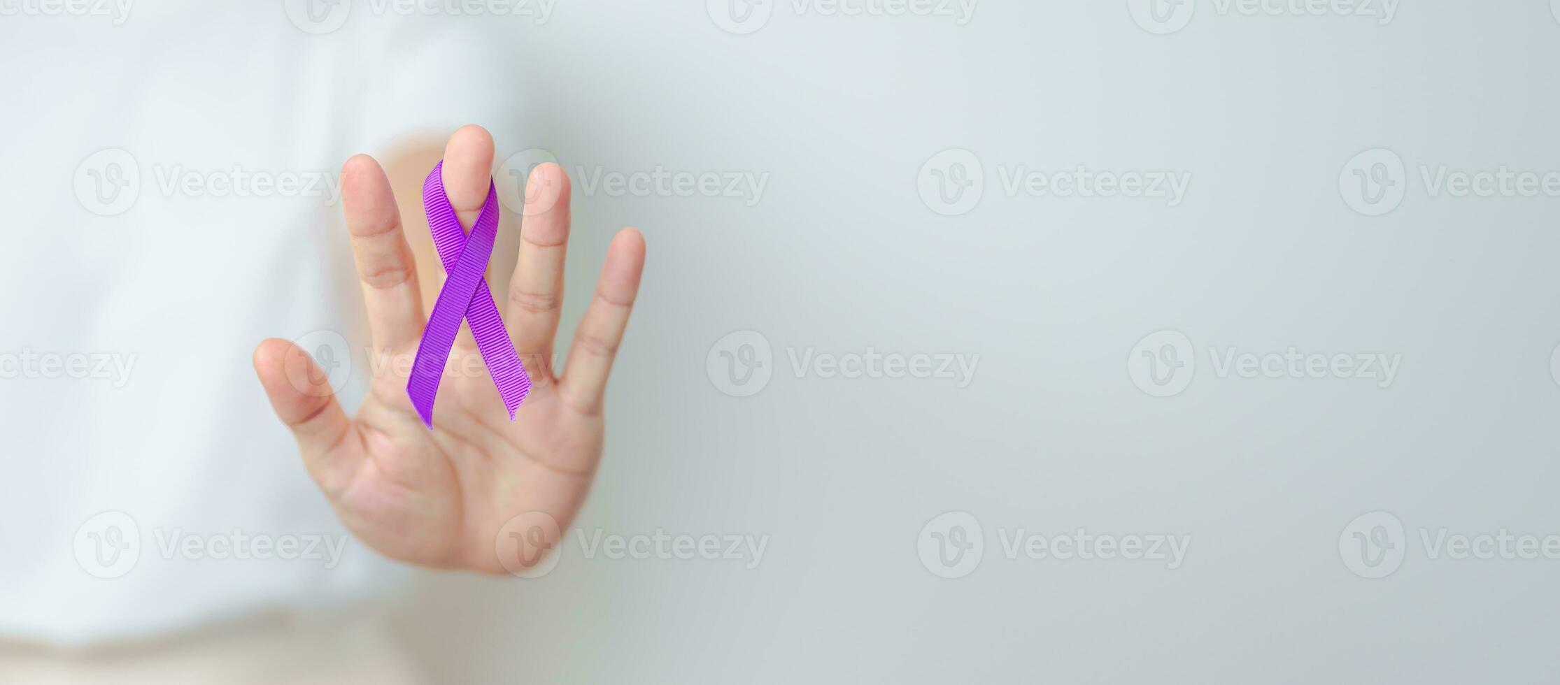 Woman holding purple Ribbon for Violence, Pancreatic, Esophageal, Testicular cancer, Alzheimer, epilepsy, lupus, Sarcoidosis and Fibromyalgia. Awareness month and World cancer day concept photo