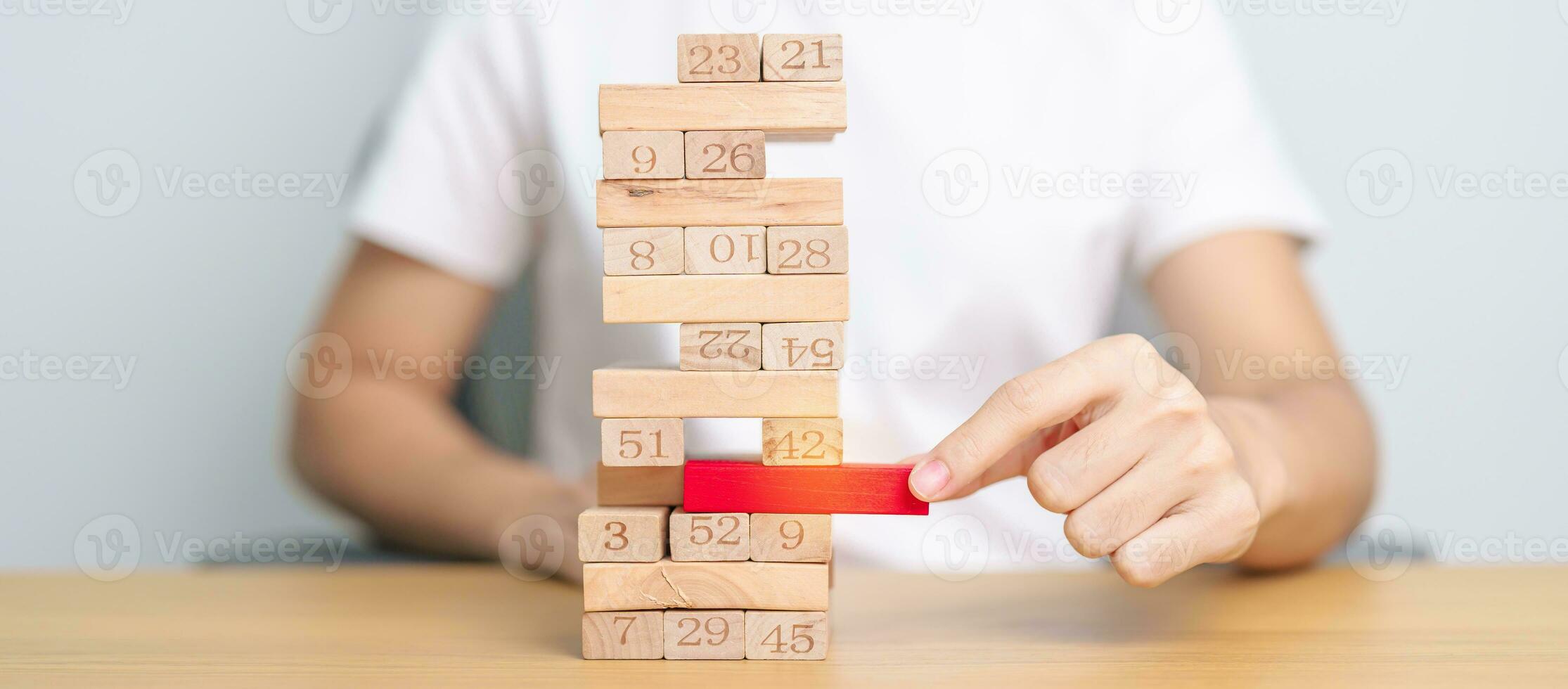 hand pulling wooden block tower on table. Business planning, Risk Management, Solution, leader, strategy, Crisis, falling Business, and Economic recession concept photo