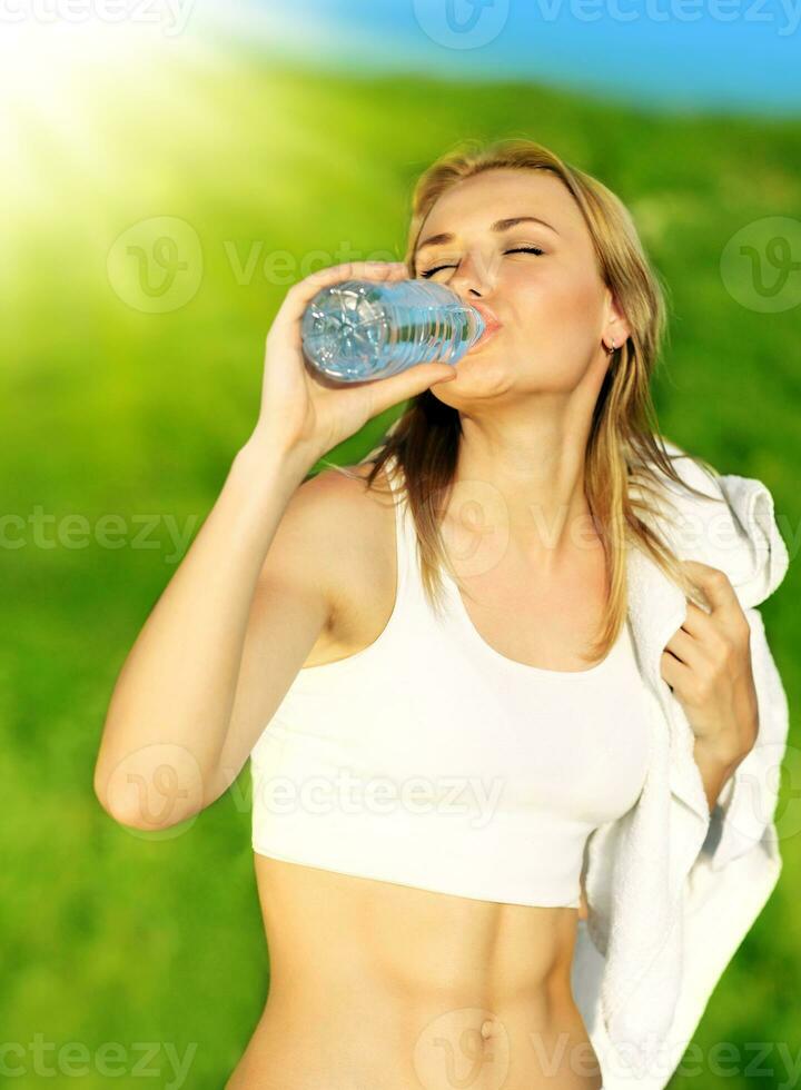 Healthy woman drinks water photo