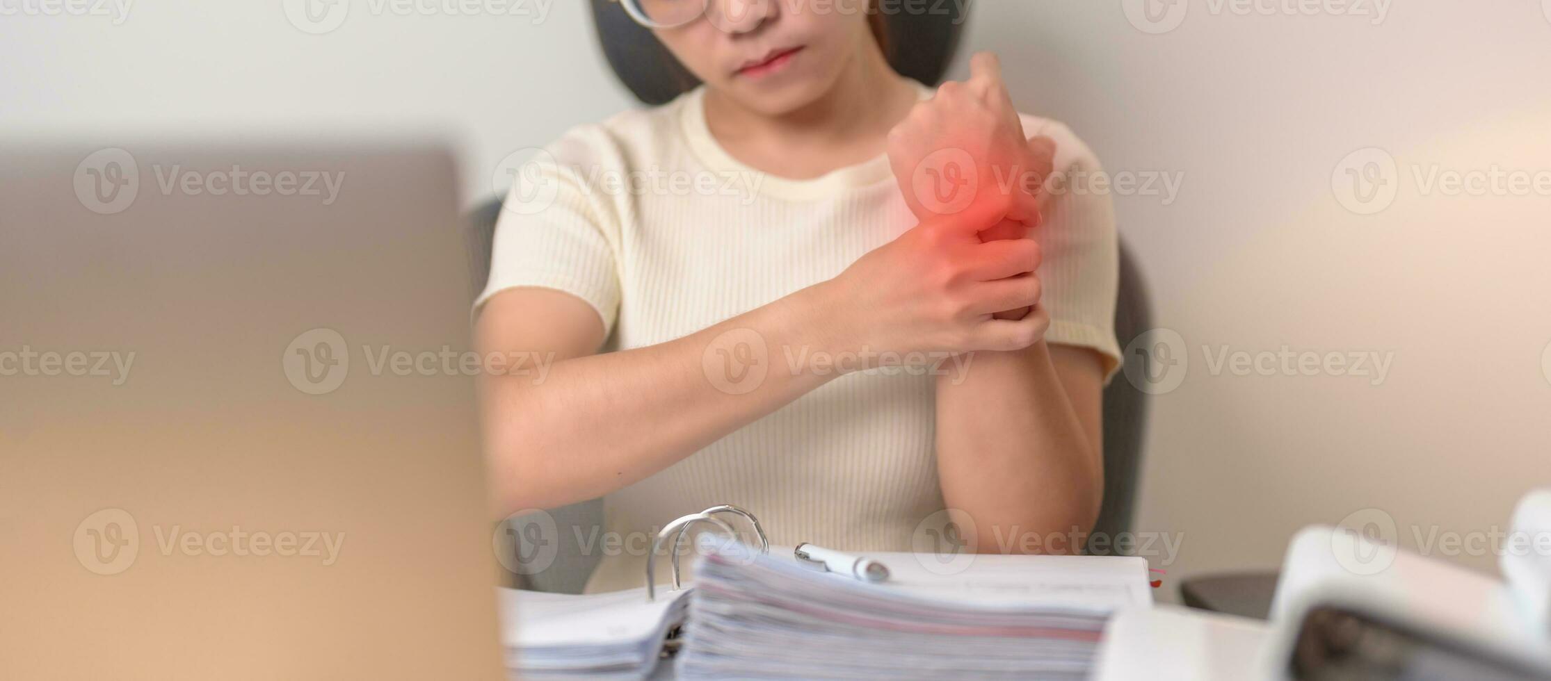 Woman having wrist pain when using laptop computer and mouse during working long time on workplace. De Quervain s tenosynovitis, rheumatism ergonomic, Carpal Tunnel Syndrome or Office syndrome concept photo