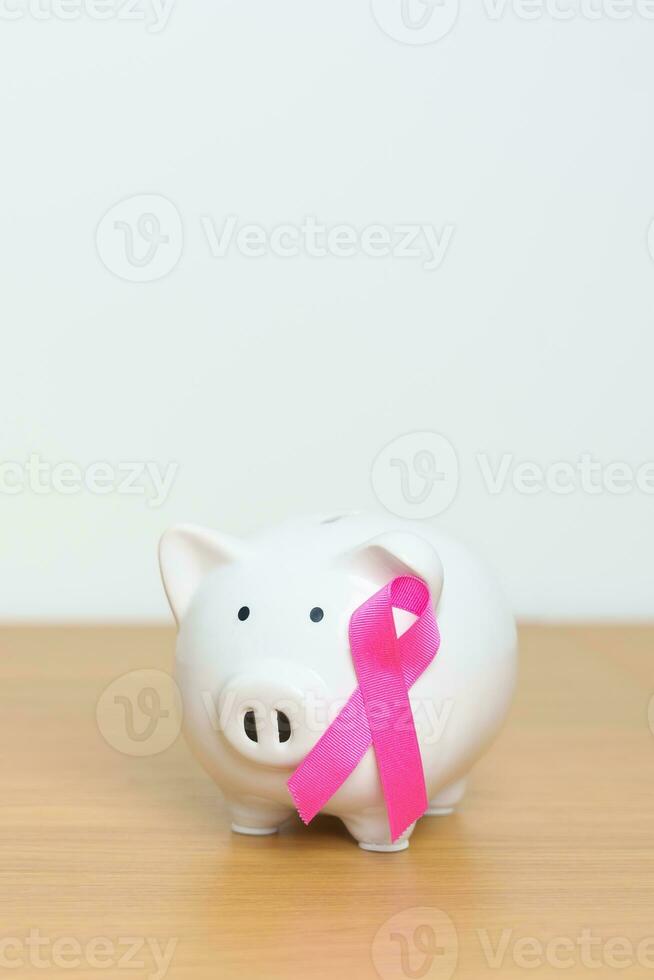 October Breast Cancer Awareness month, Pink Ribbon with Piggy Bank for support illness life. Health, Donation, Charity, Campaign, Money Saving, Fund, women day and World cancer day concept photo