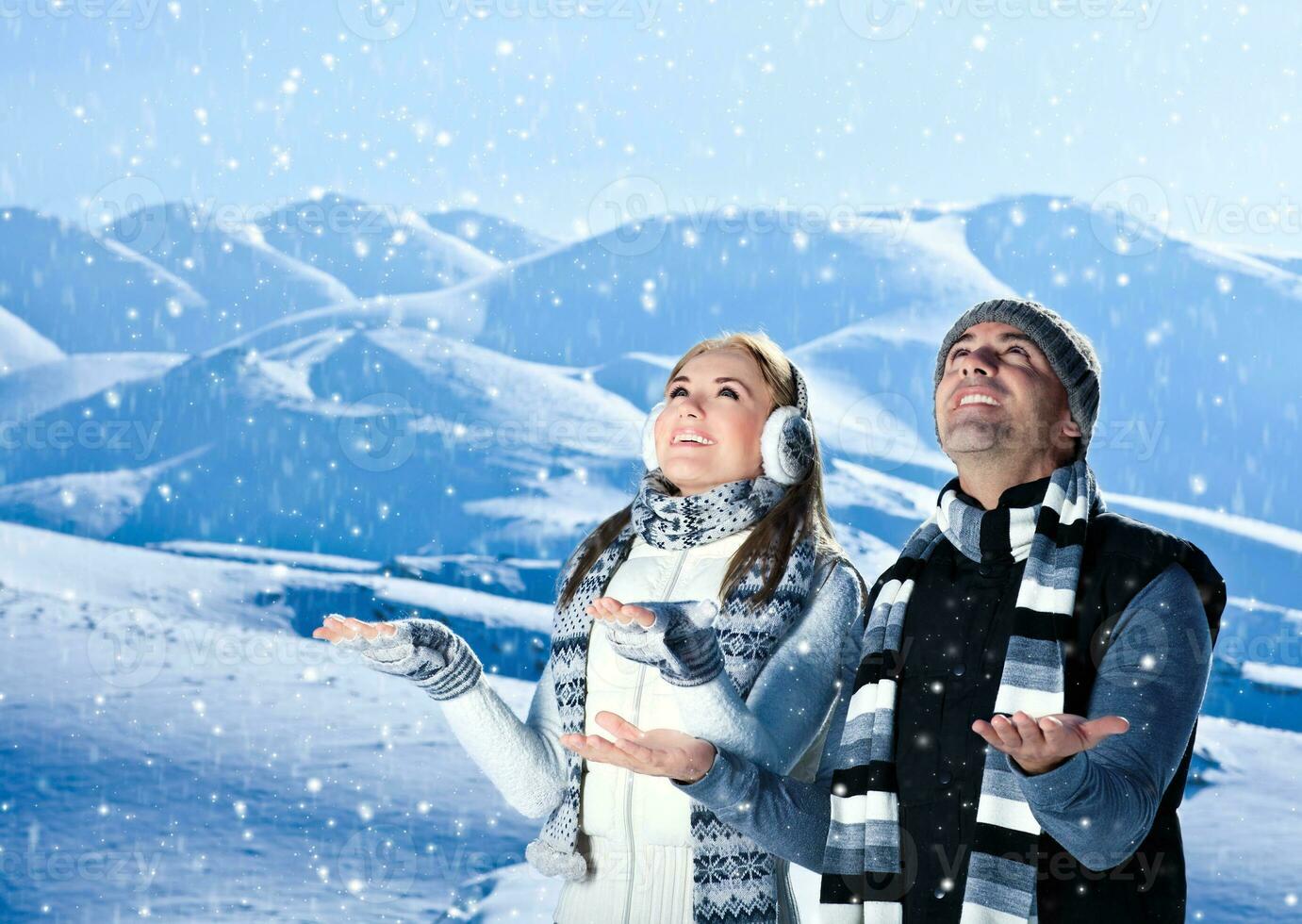 Happy couple playing outdoor at winter mountains photo
