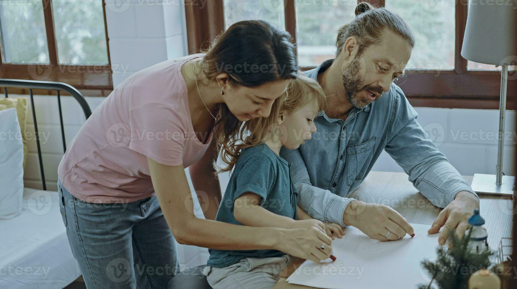 Caucasian family painting on paper with son indoors in house. Little son learn how to draw art picture enjoy creativity with mother and father in house. photo