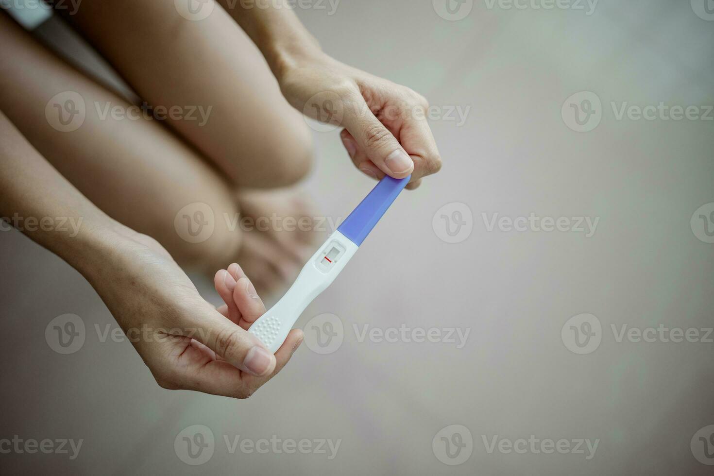 Unhappy young asian woman holding pregnancy test showing a negative result. Healthy and infertility problem concept . photo