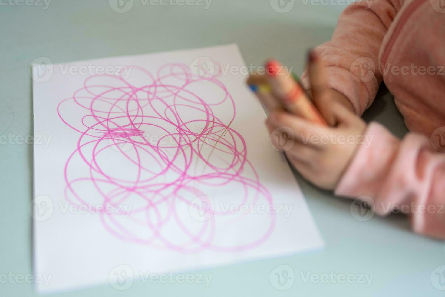 a small child is learning to draw a picture photo