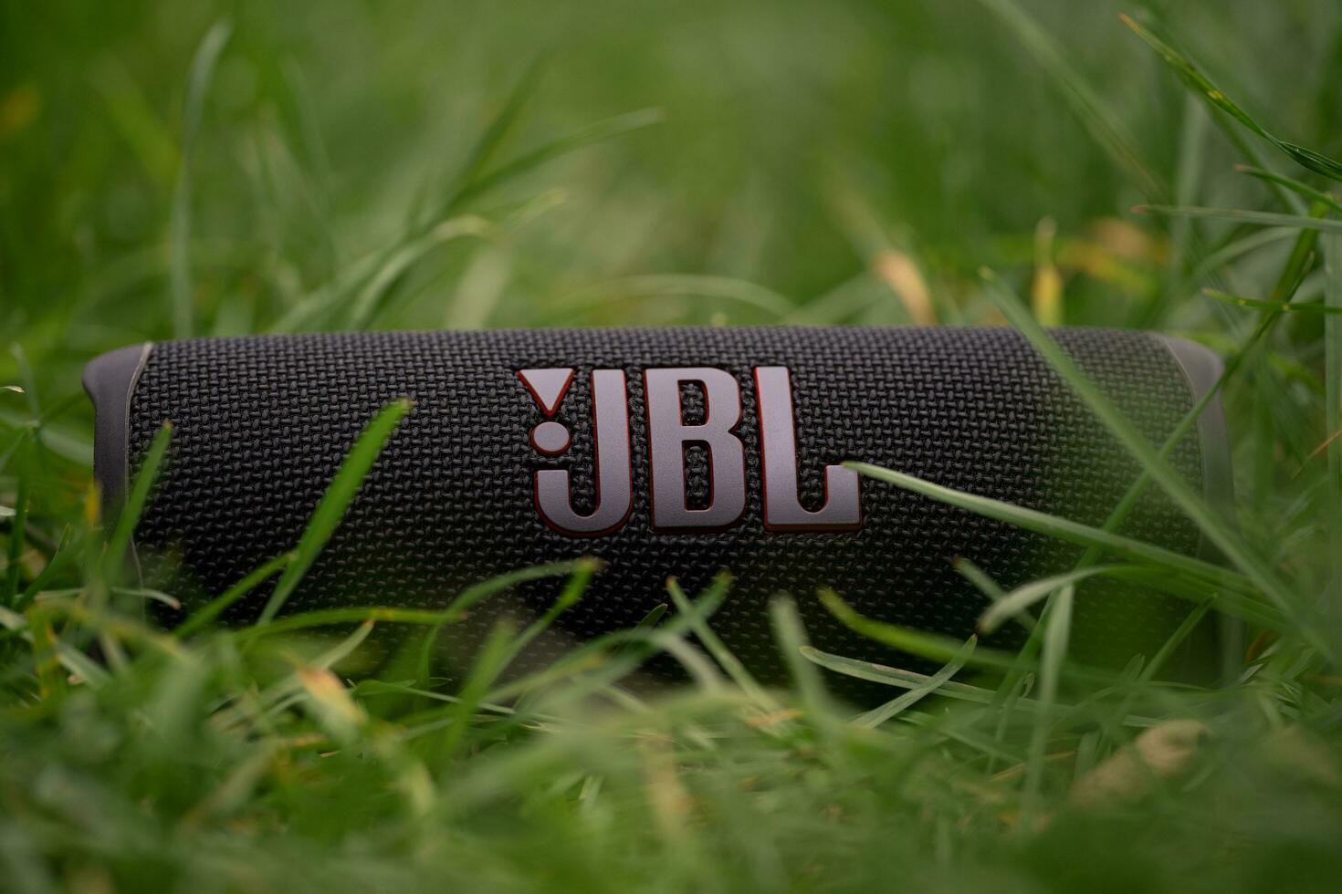 LVIV, UKRAINE  OCTOBER 12, 2022 JBL Flip 6 Black, portable bluetooth speaker outdoors. photo