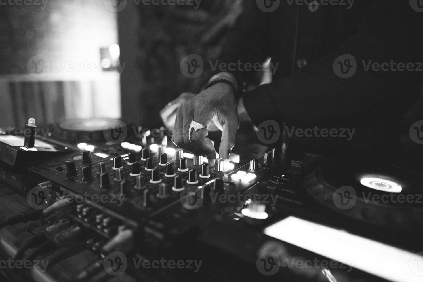 a DJ plays music on a controller at a party photo