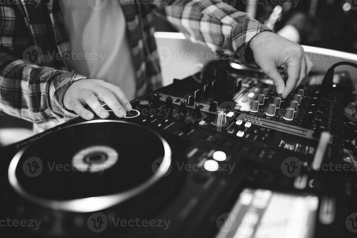 a DJ plays music on a controller at a party photo