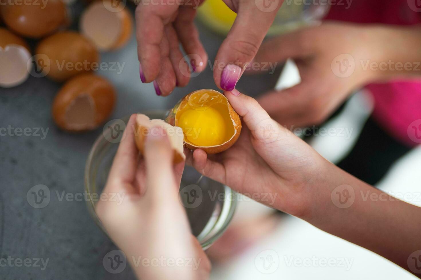 the cook breaks the chicken egg while preparing a delicious dish photo