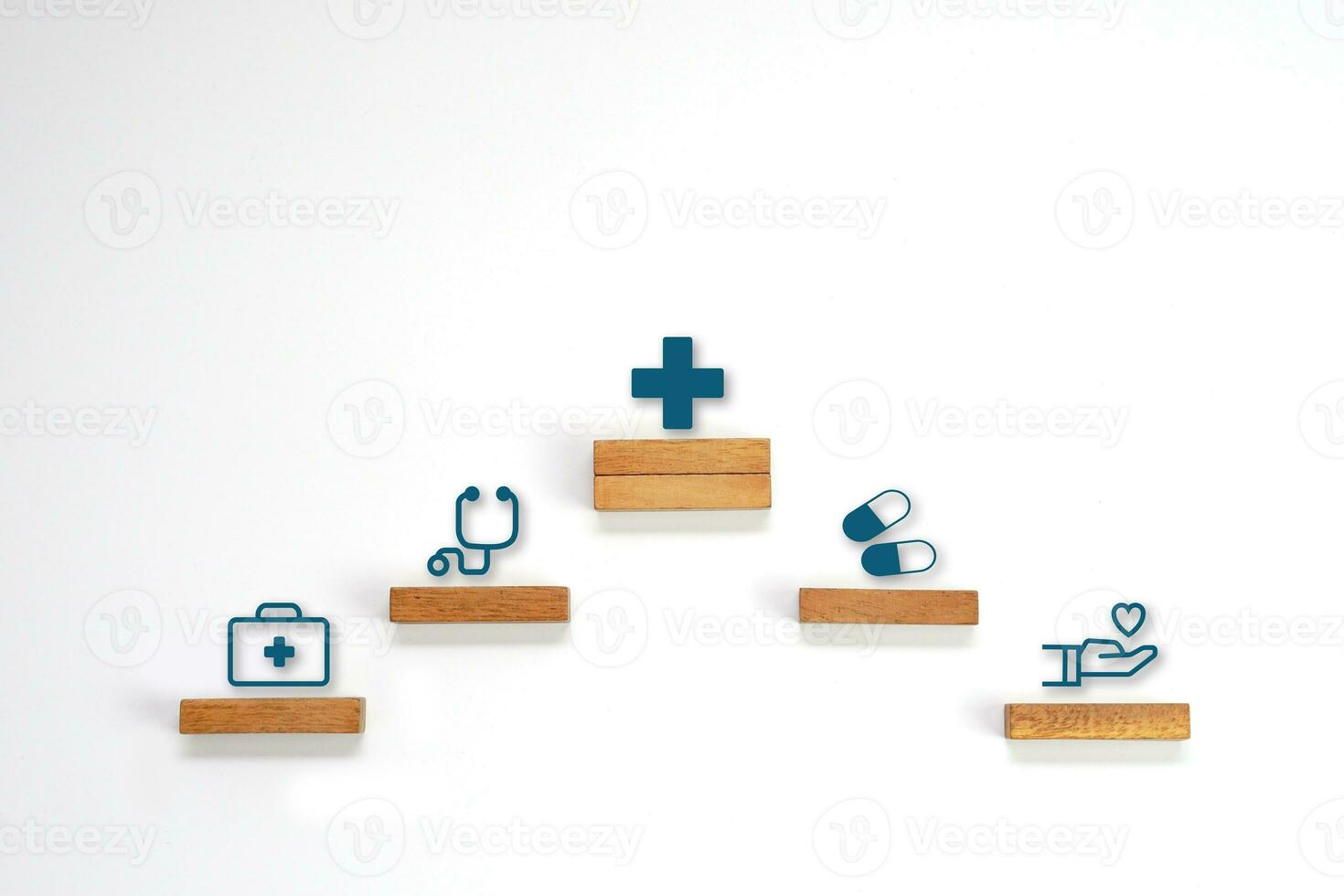 Medical icon symbol on a wooden block cube arranged in steps. Health care, health insurance and treatment  concept. photo