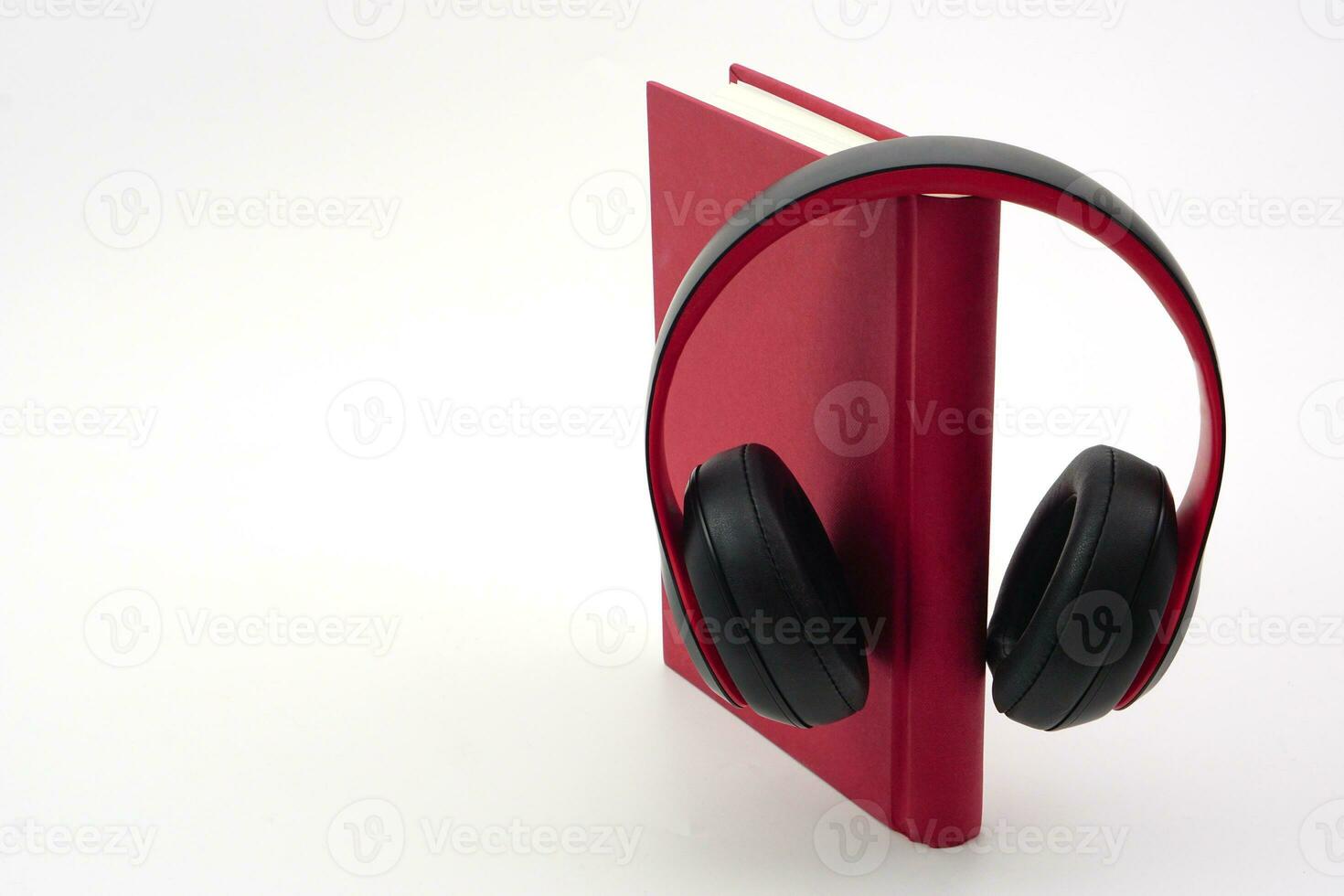 Stack of books with headphones hanging on. Modern education and relaxation concept. photo