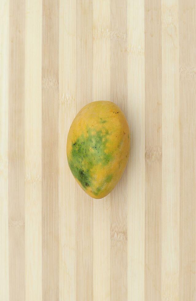 mango fruit on wooden surface photo