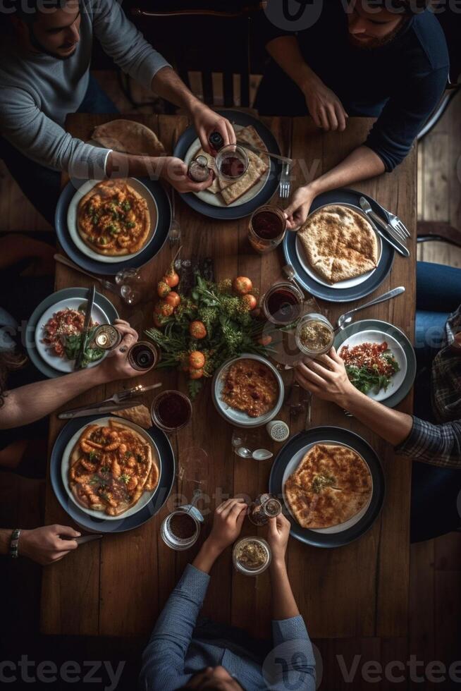 Dining with friends Top view of four people having dinner together