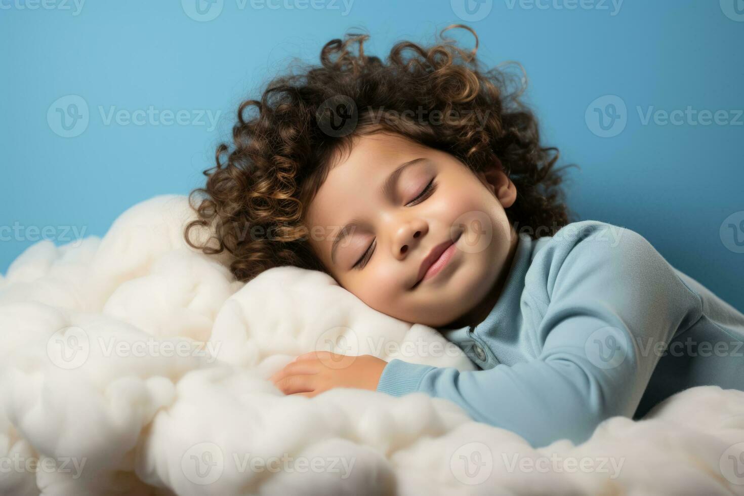 A child peacefully sleeping on a cloud bed isolated on a soft blue gradient background photo
