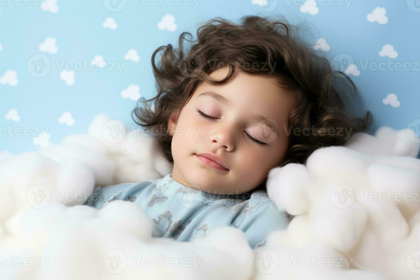 A child peacefully sleeping on a cloud isolated on a white background photo