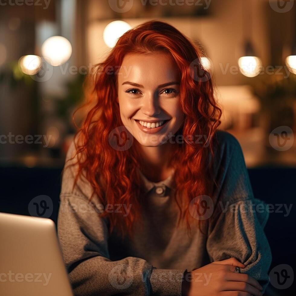 Woman working on laptop and smiling. photo