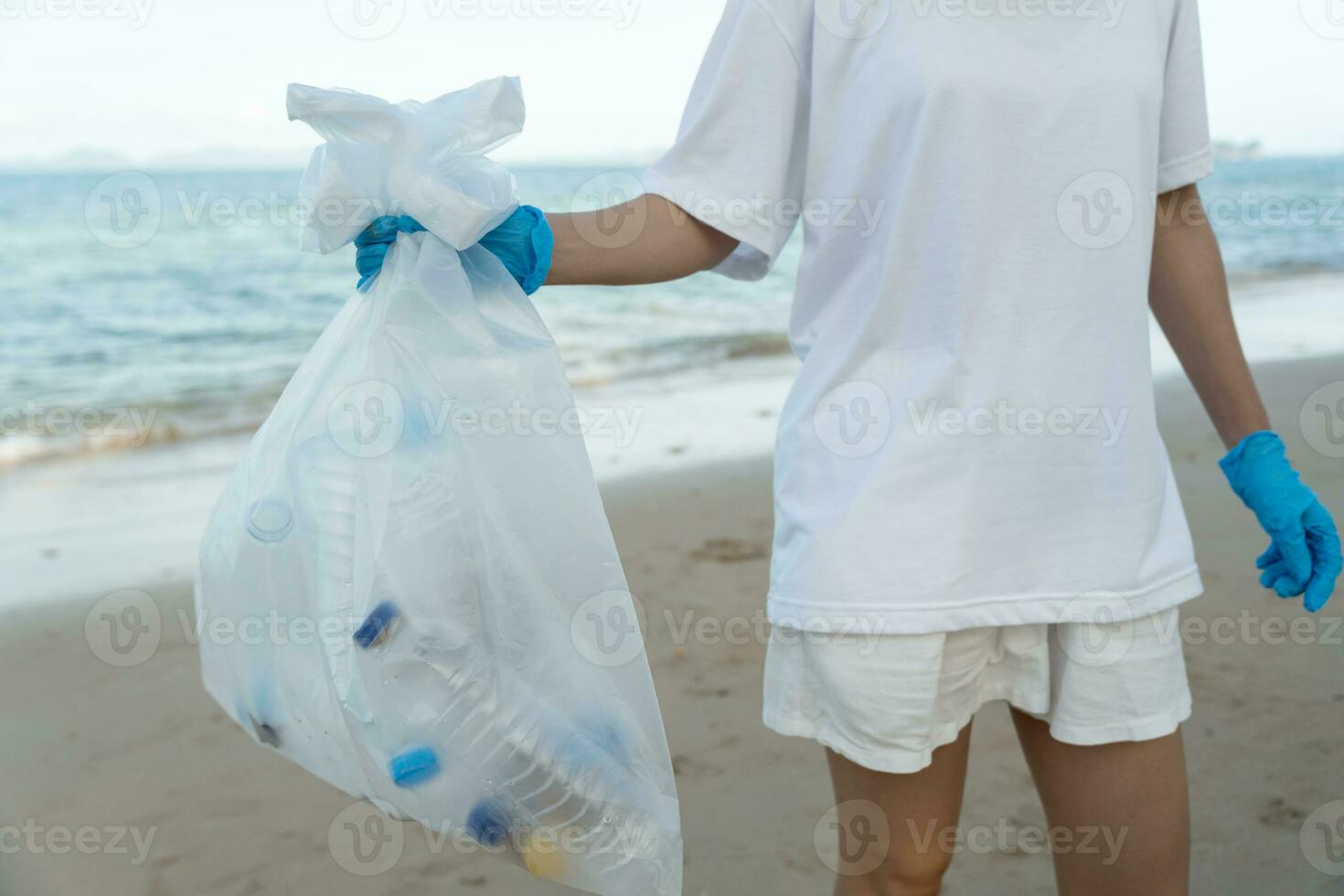 Save ocean. Volunteer pick up trash garbage at the beach and plastic bottles are difficult decompose prevent harm aquatic life. Earth, Environment, Greening planet, reduce global warming, Save world photo