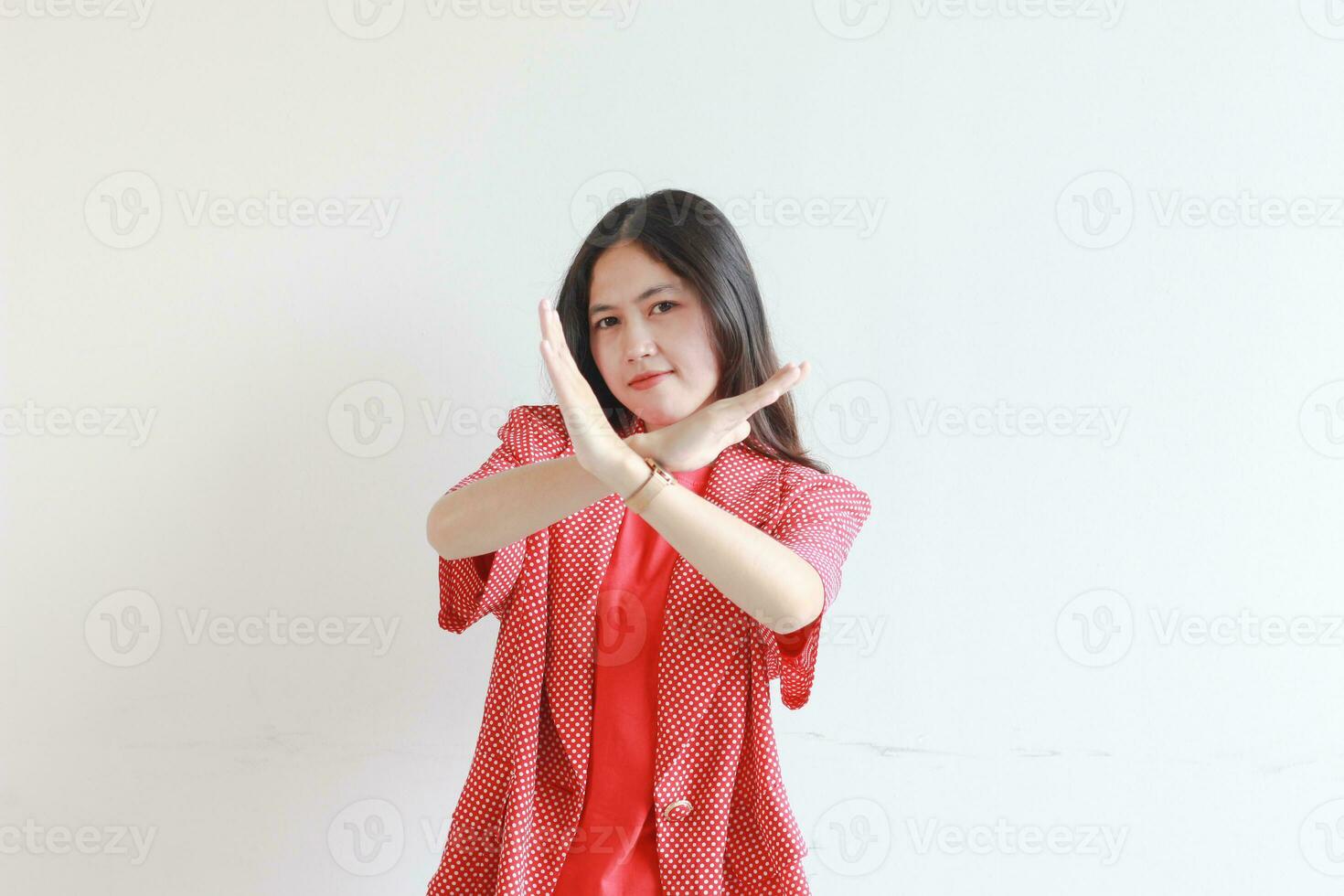 portrait of beautiful asian woman wearing red outfit with rejection or disapproval gesture photo