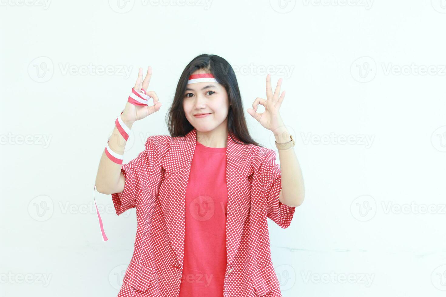 portrait of beautiful asian woman wearing red outfit with agree or OK gesture while smiling for celebrating Indonesia independence day photo