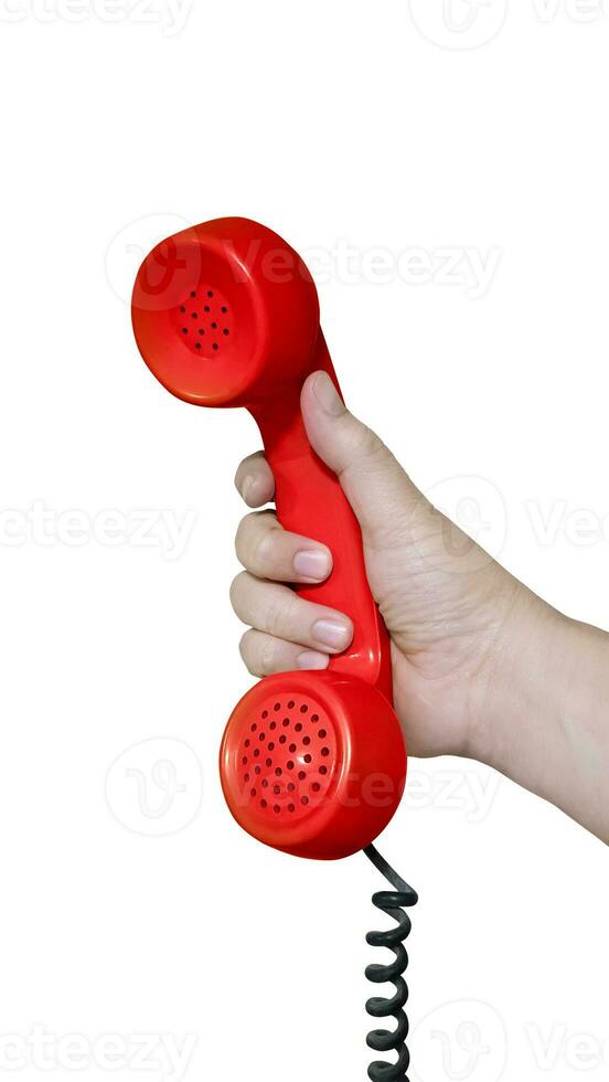 antiguo pasado de moda rojo escritorio teléfono auriculares en mano aislado en blanco antecedentes. foto