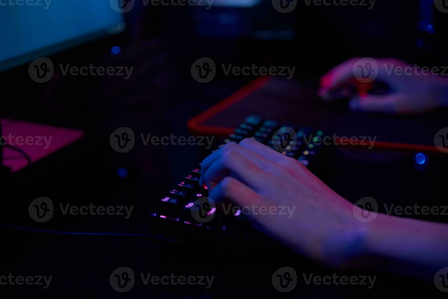 Gamer play computer game, use rgb neon colored keyboard photo