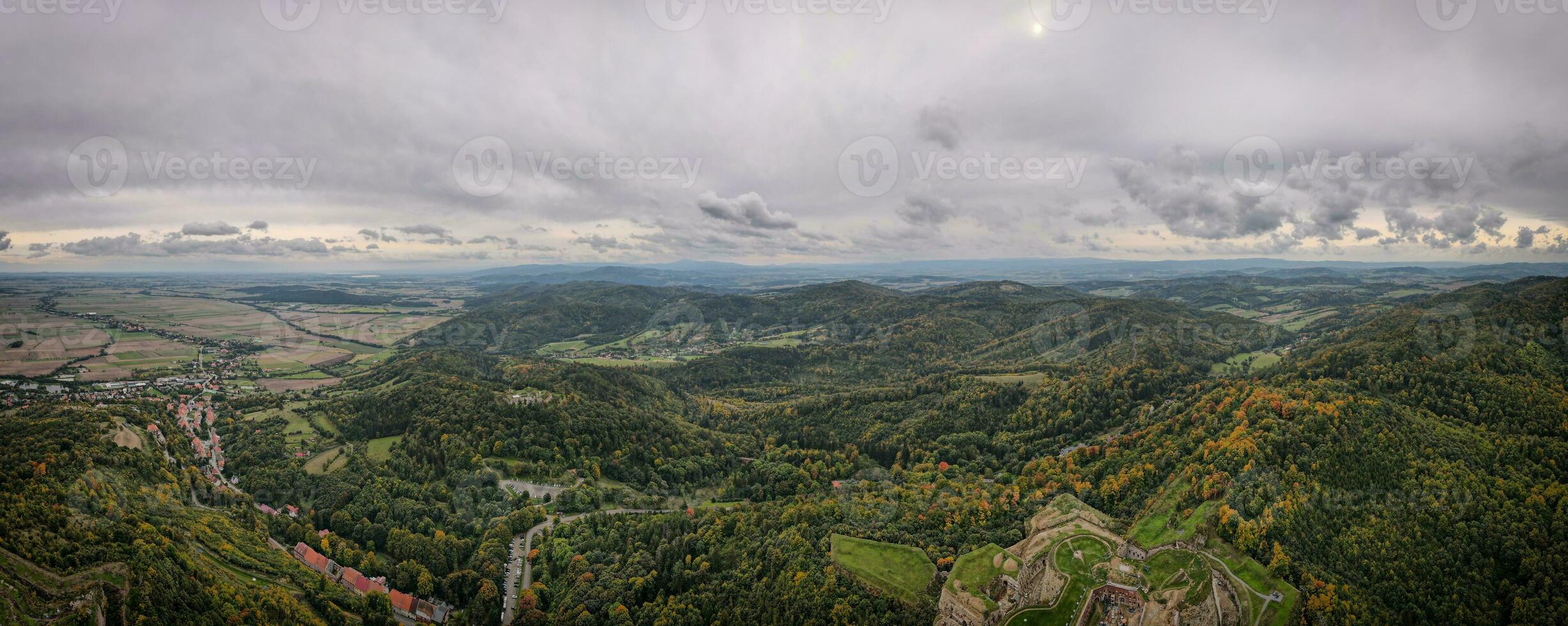 Frone flight over mountain landscape with autumn forest. Mountain village photo