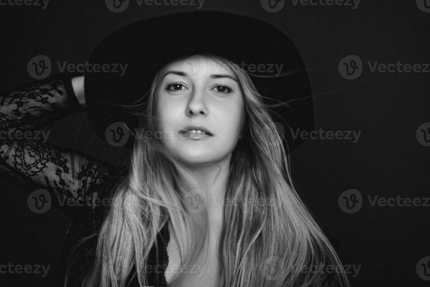 Beautiful blonde woman wearing a hat, artistic film portrait in black and white for fashion campaign and beauty brand photo