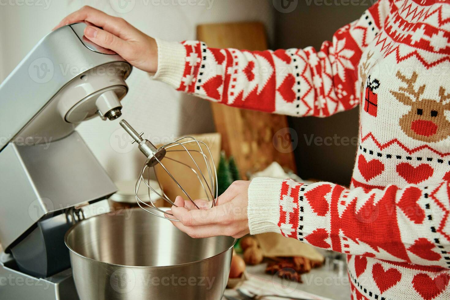 Working With A Handheld Electric Mixer In The Kitchen Stock Photo