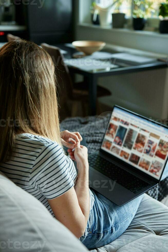 Woman at home using laptop. Remote work at home office photo