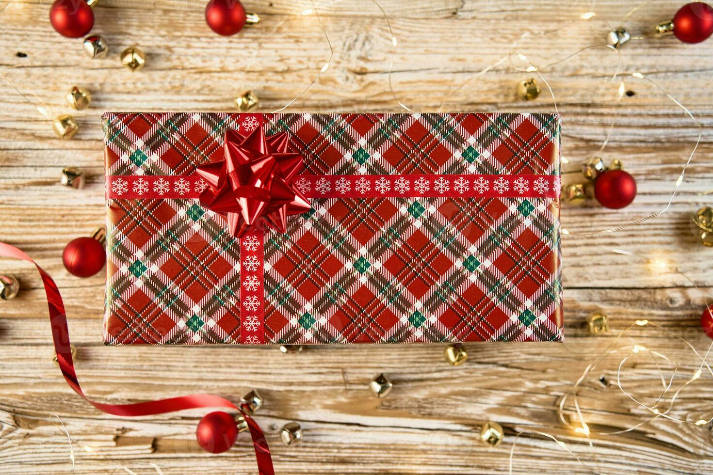 Festive gift box on wooden background. Present for holiday photo