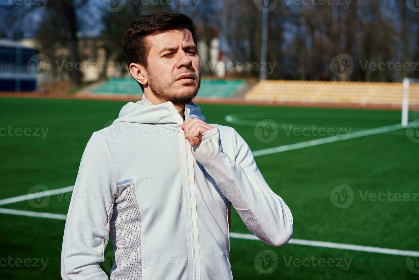 Portrait of man preparing for fitness at stadium track photo