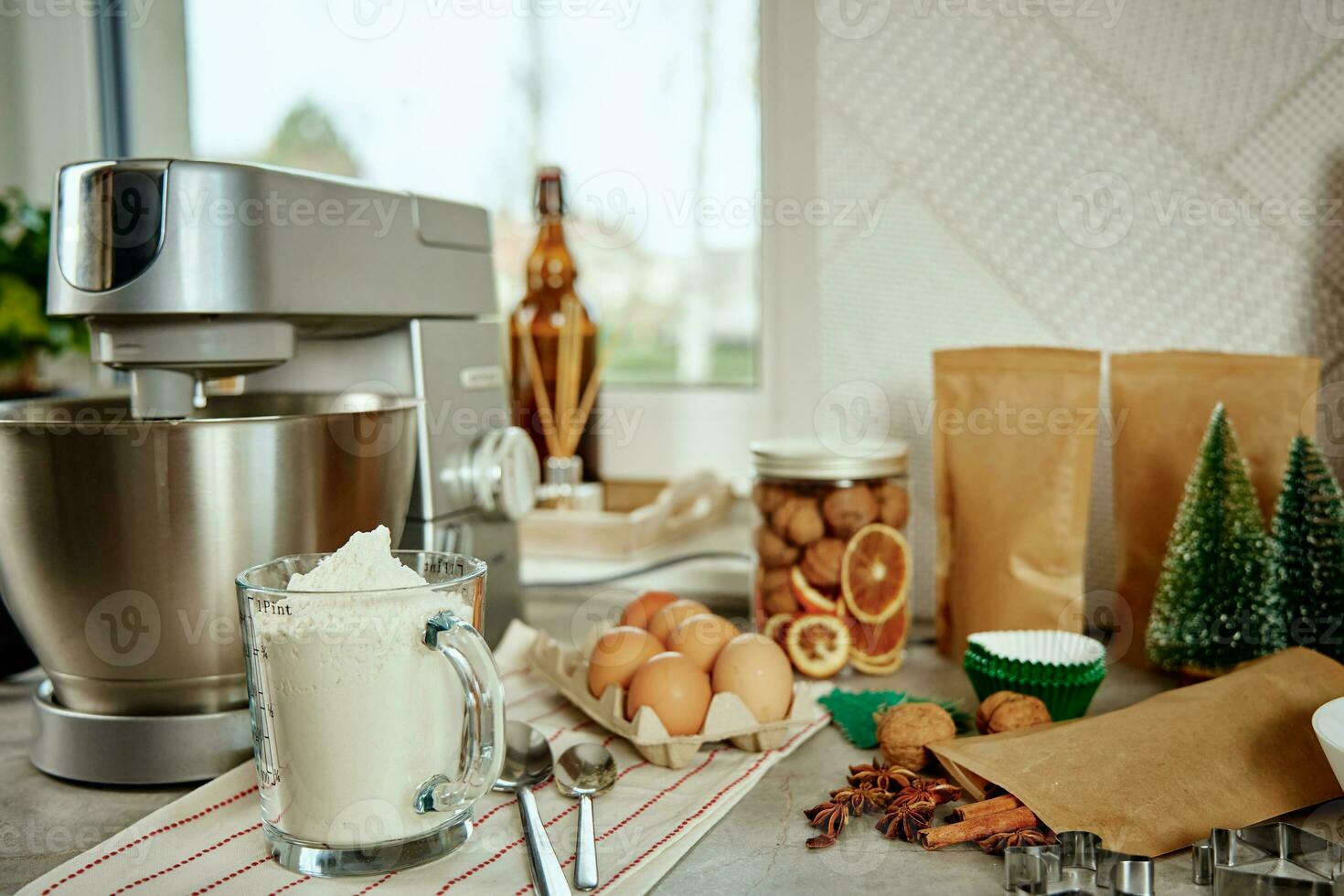 Electric mixer kneads dough in the kitchen photo