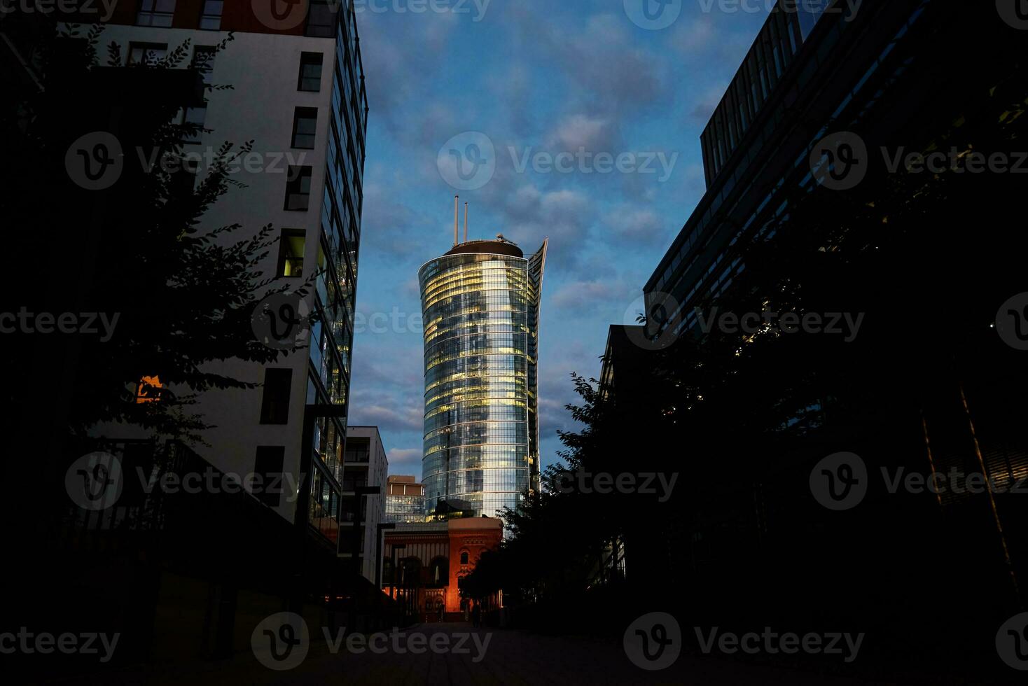 High rise office building with illuminated windows at night photo