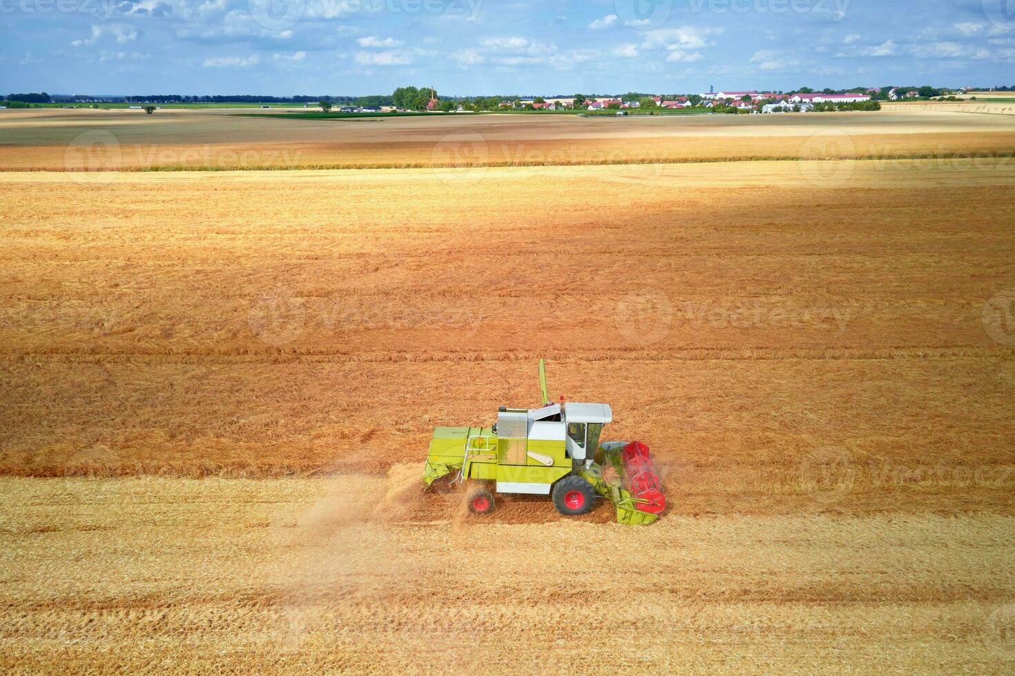 Aerial view of working harvesting combine in wheat field, Harvest season photo