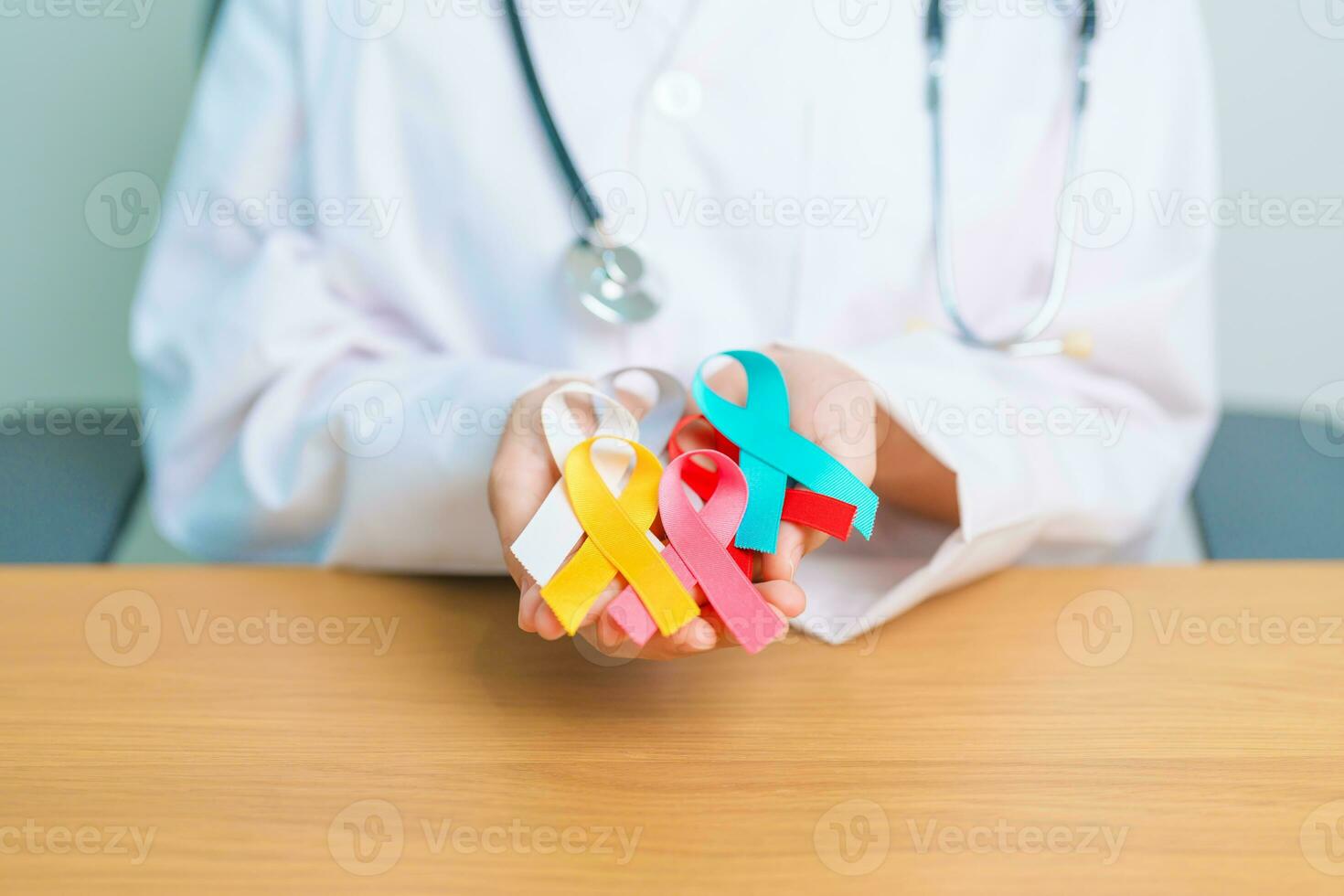 World cancer day, February 4. Doctor hold colorful ribbons, blue, yellow, red, green, white, pink and grey for supporting people living and illness. Health, Medical, awareness and Insurance concept photo