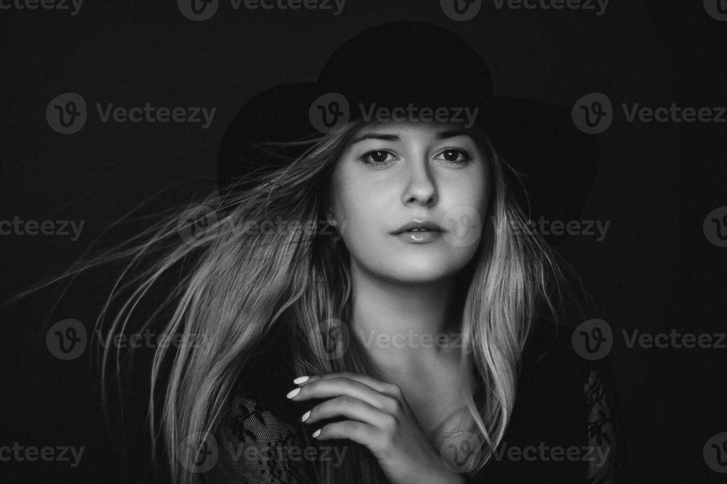 Beautiful blonde woman wearing a hat, artistic film portrait in black and white for fashion campaign and beauty brand photo