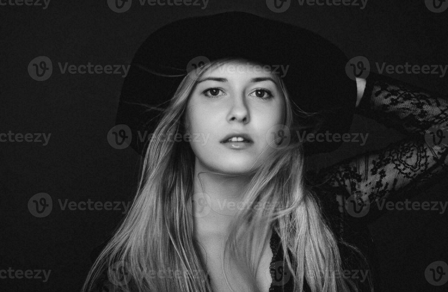 Beautiful blonde woman wearing a hat, artistic film portrait in black and white for fashion campaign and beauty brand photo