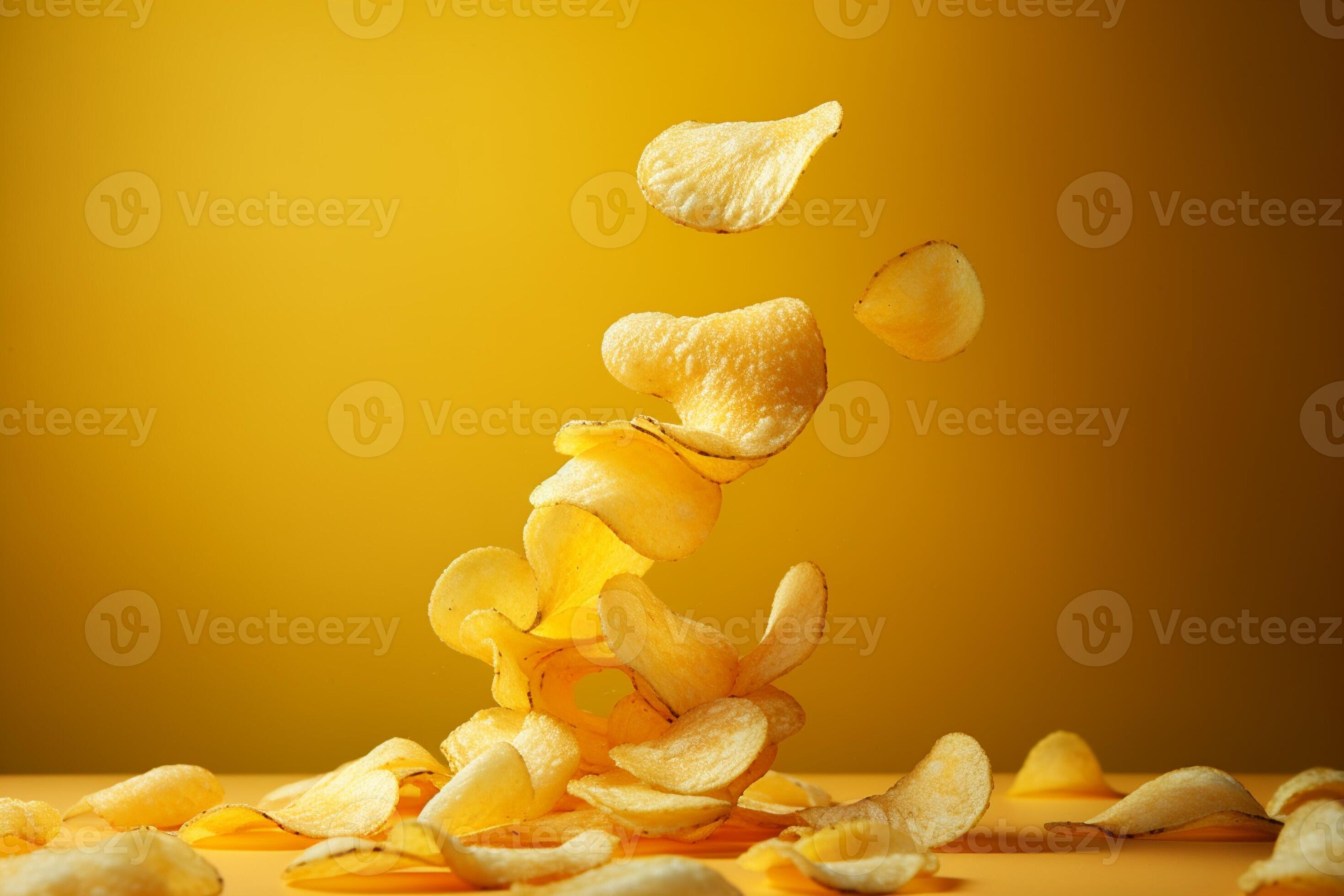 Potato chips suspended in midair, yellow background, depicting the