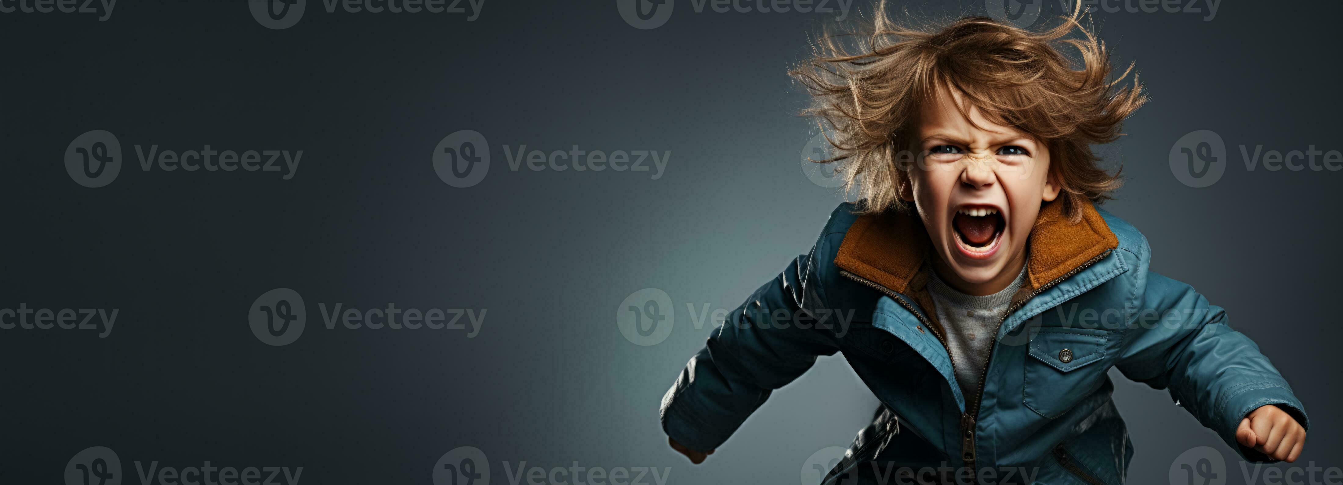 A child throwing a tantrum isolated on a stormy grey gradient