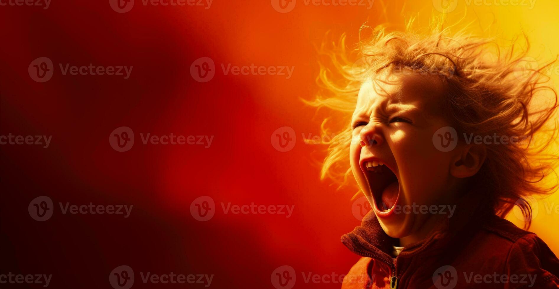 A child screaming in frustration isolated on a fiery red gradient background photo