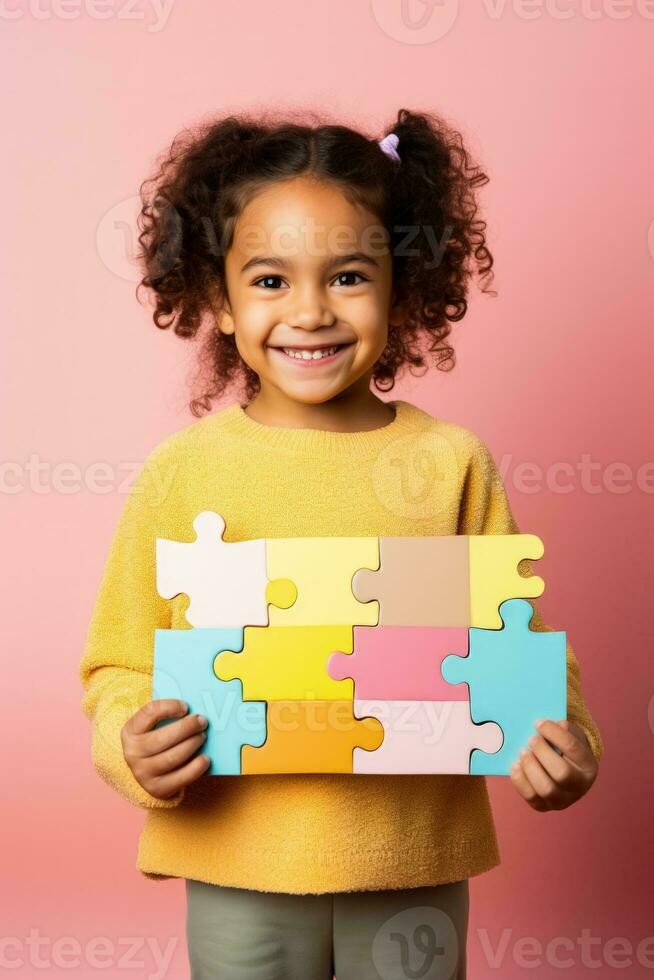 A child proudly showing a completed puzzle isolated on a bright gradient background photo