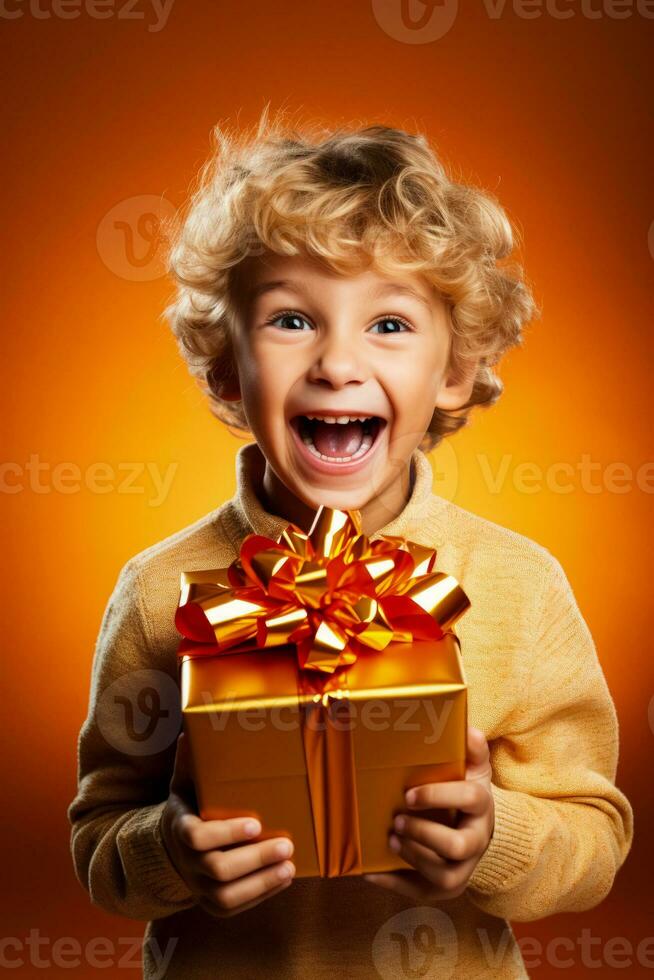 Excited child unwrapping a gift isolated on a festive gradient background photo