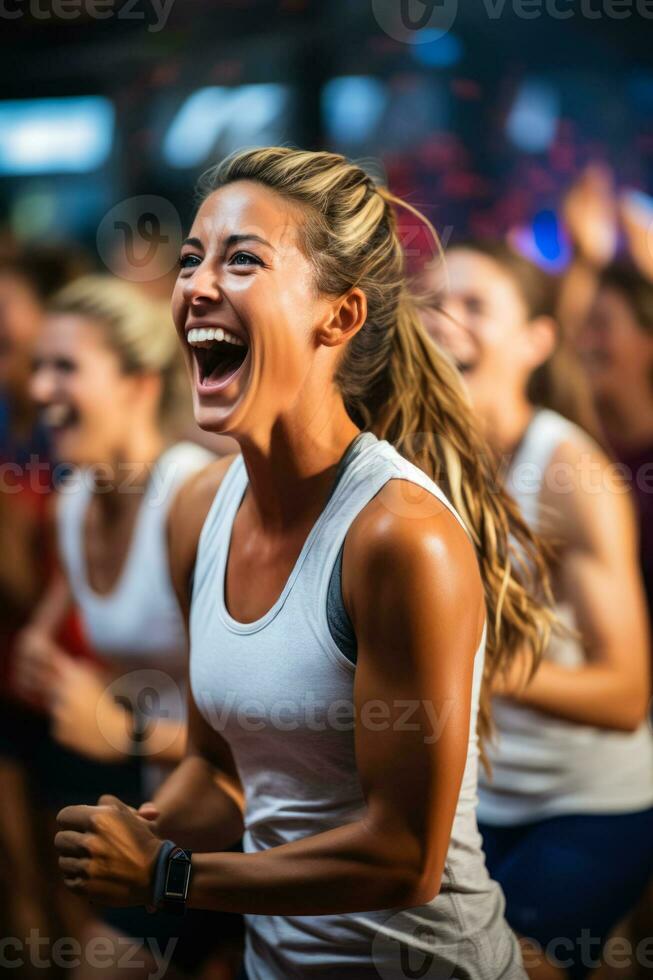 Enthusiastic group performing energetic aerobic exercises in lively fitness club atmosphere photo