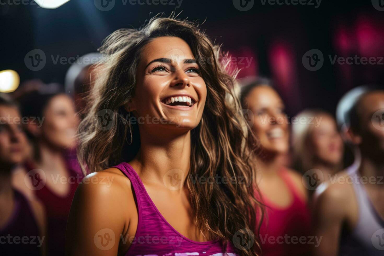 Enthusiastic group performing energetic aerobic exercises in lively fitness club atmosphere photo