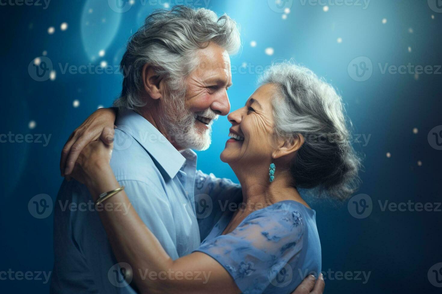 a elderly couple dancing happily and looking to each other in happiness photo