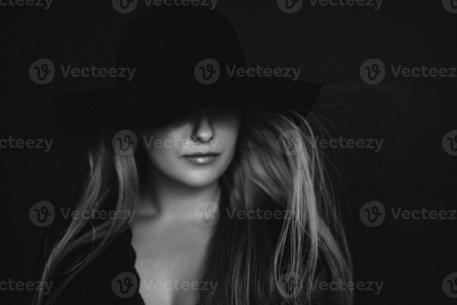 Beautiful blonde woman wearing a hat, artistic film portrait in black and white for fashion campaign and beauty brand photo